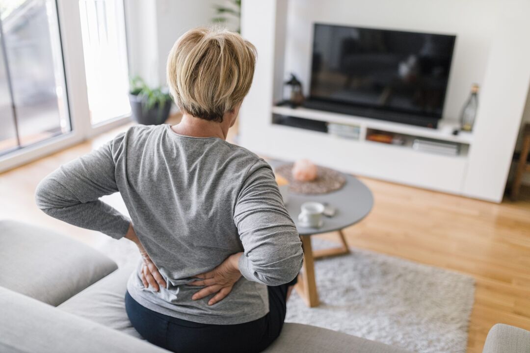 Une femme s’inquiète des maux de dos dans la région lombaire